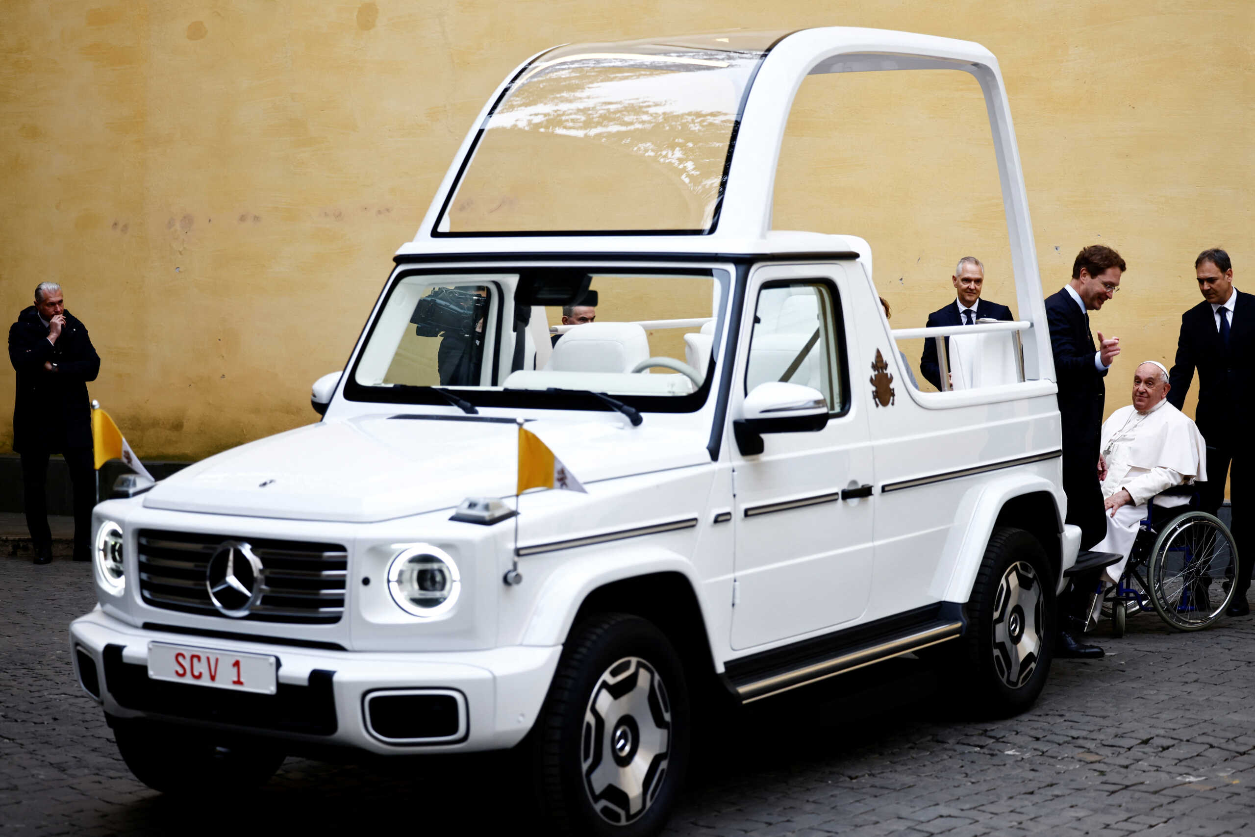 Pope Francis reacts as he receives a new open popemobile next to Mercedes-Benz Group CEO Ola Kallenius at the Vatican, December 4, 2024. REUTERS