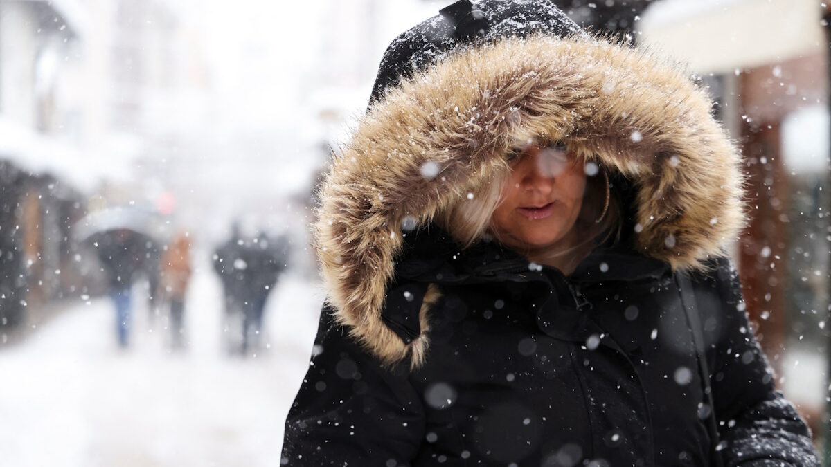 A woman walks on the street during snowstorm in Sarajevo, Bosnia and Herzegovina, December 24, 2024.REUTERS