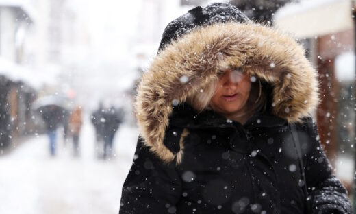 A woman walks on the street during snowstorm in Sarajevo, Bosnia and Herzegovina, December 24, 2024.REUTERS