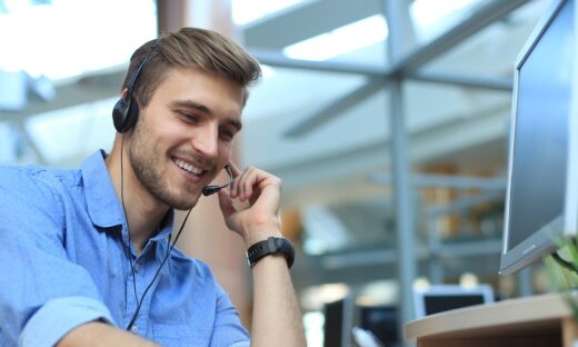 Smiling friendly handsome young male call centre operator