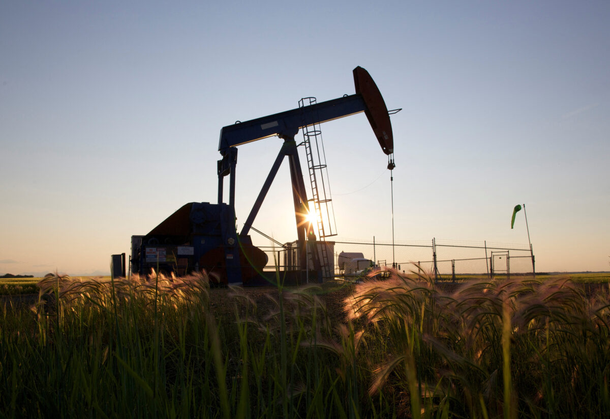 An oil pump jack pumps oil in a field near Calgary, Alberta