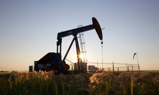 An oil pump jack pumps oil in a field near Calgary, Alberta