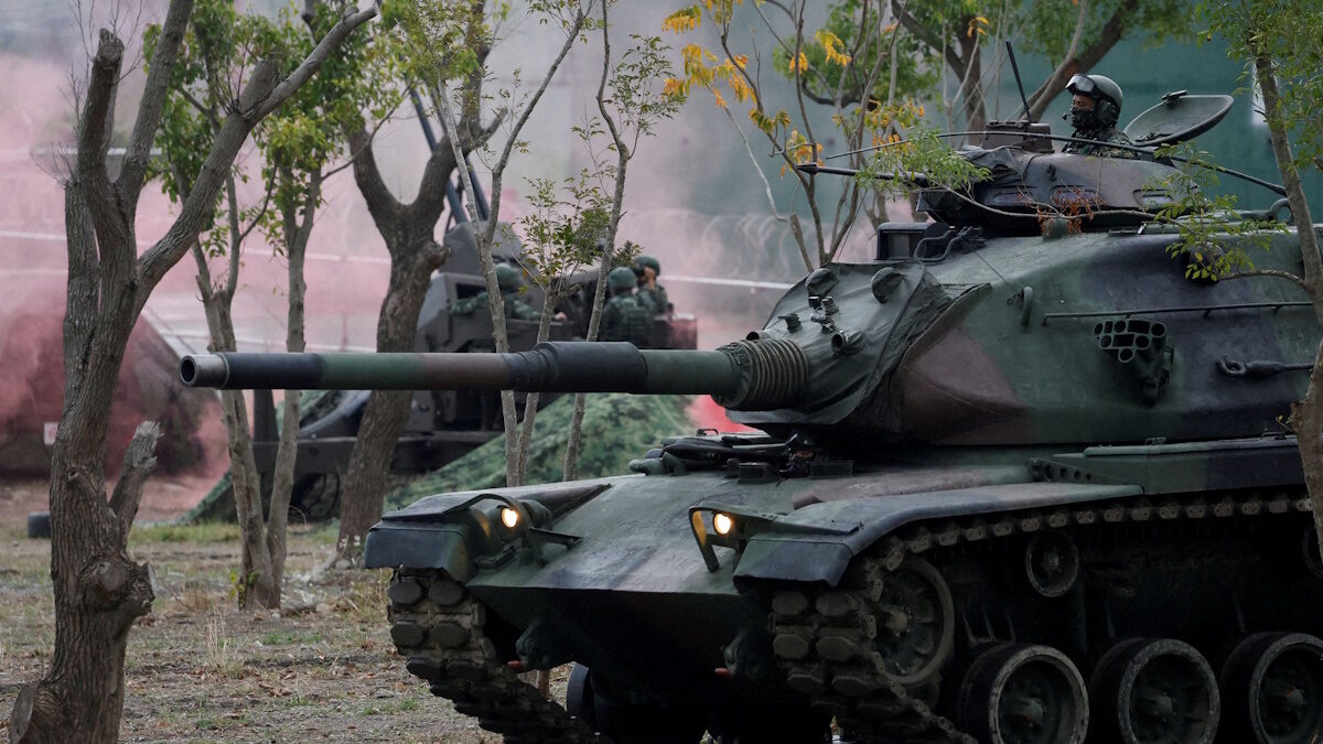 Members of Taiwan's armed forces, riding on a M60A3 tank