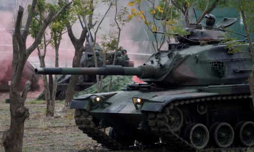 Members of Taiwan's armed forces, riding on a M60A3 tank