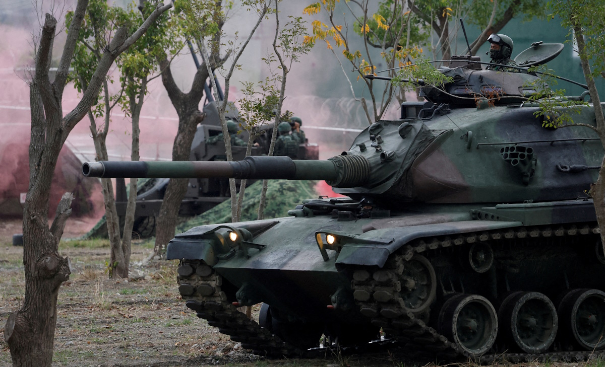 Members of Taiwan's armed forces, riding on a M60A3 tank