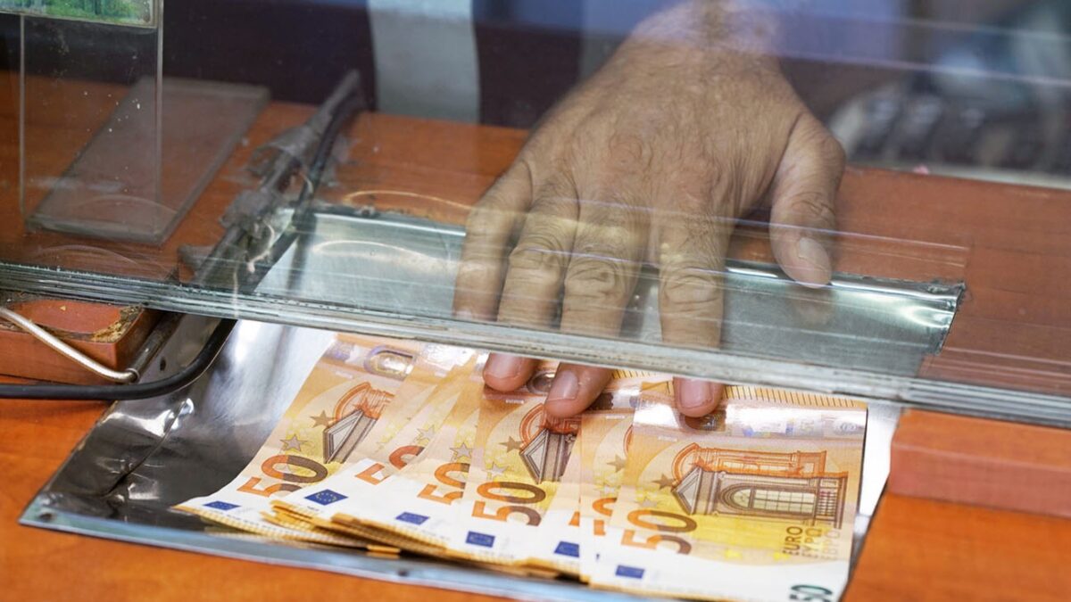 Clerk giving cash money to customer at bank office