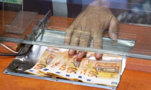 Clerk giving cash money to customer at bank office