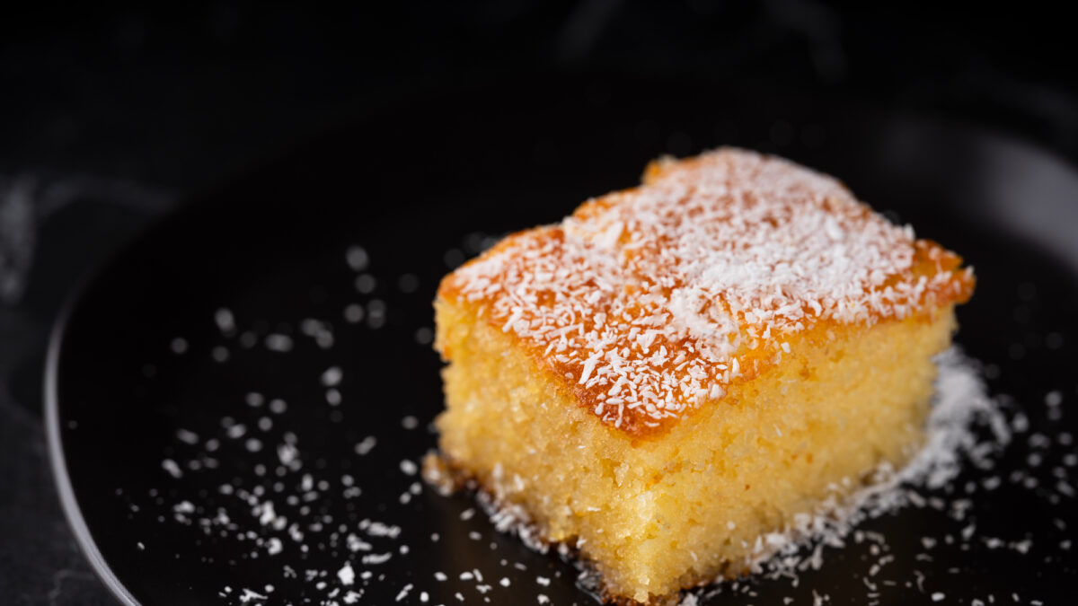 Revani dessert, Turkish traditional pastry dessert on a black plate