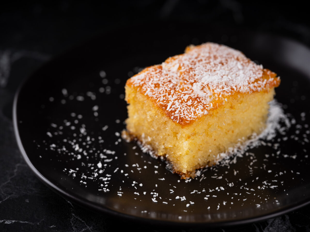 Revani dessert, Turkish traditional pastry dessert on a black plate