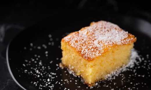 Revani dessert, Turkish traditional pastry dessert on a black plate