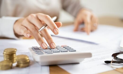 Business woman using calculator to manage finance