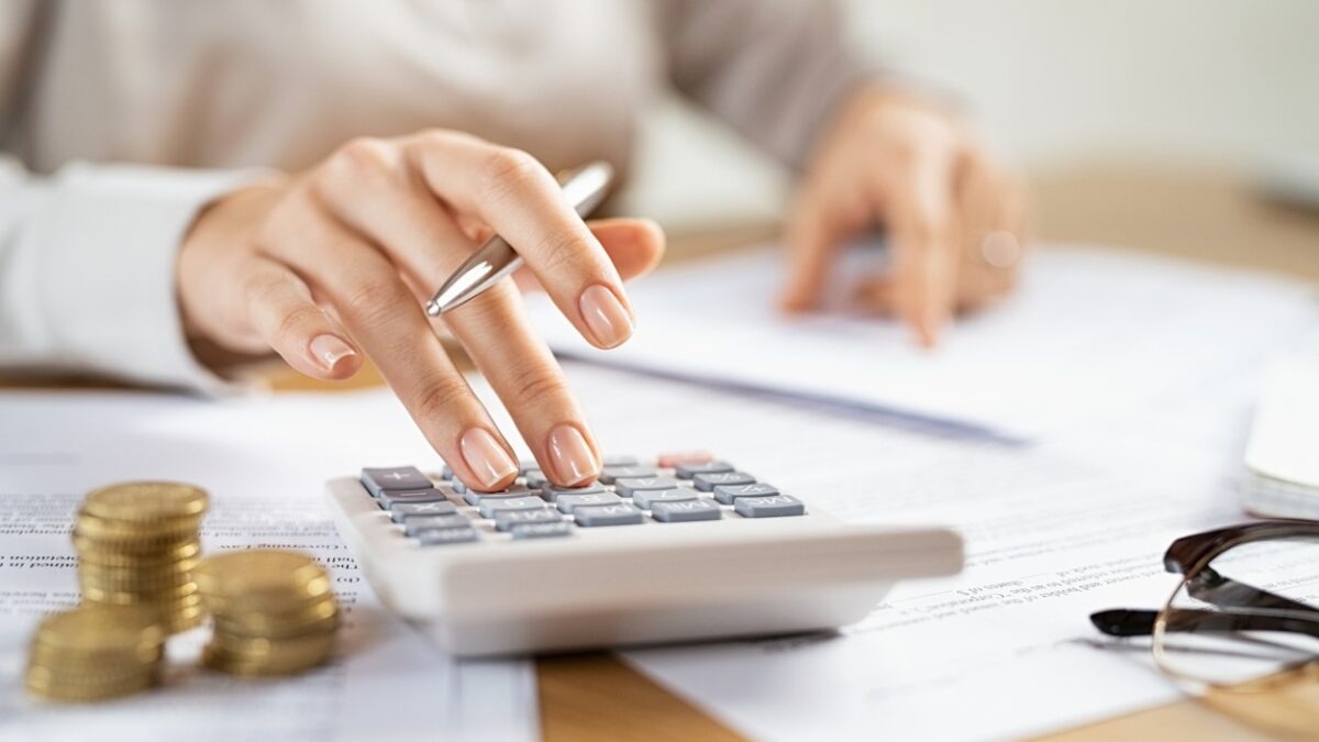 Business woman using calculator to manage finance