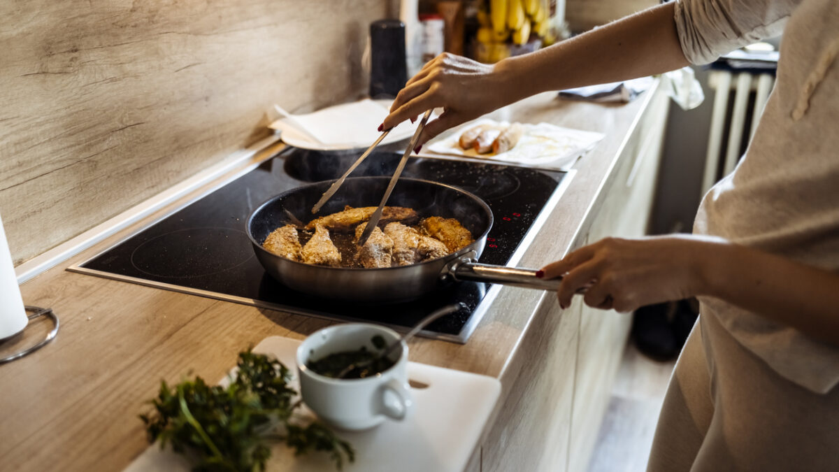 Woman preparing red mullet fishes in home kitchen