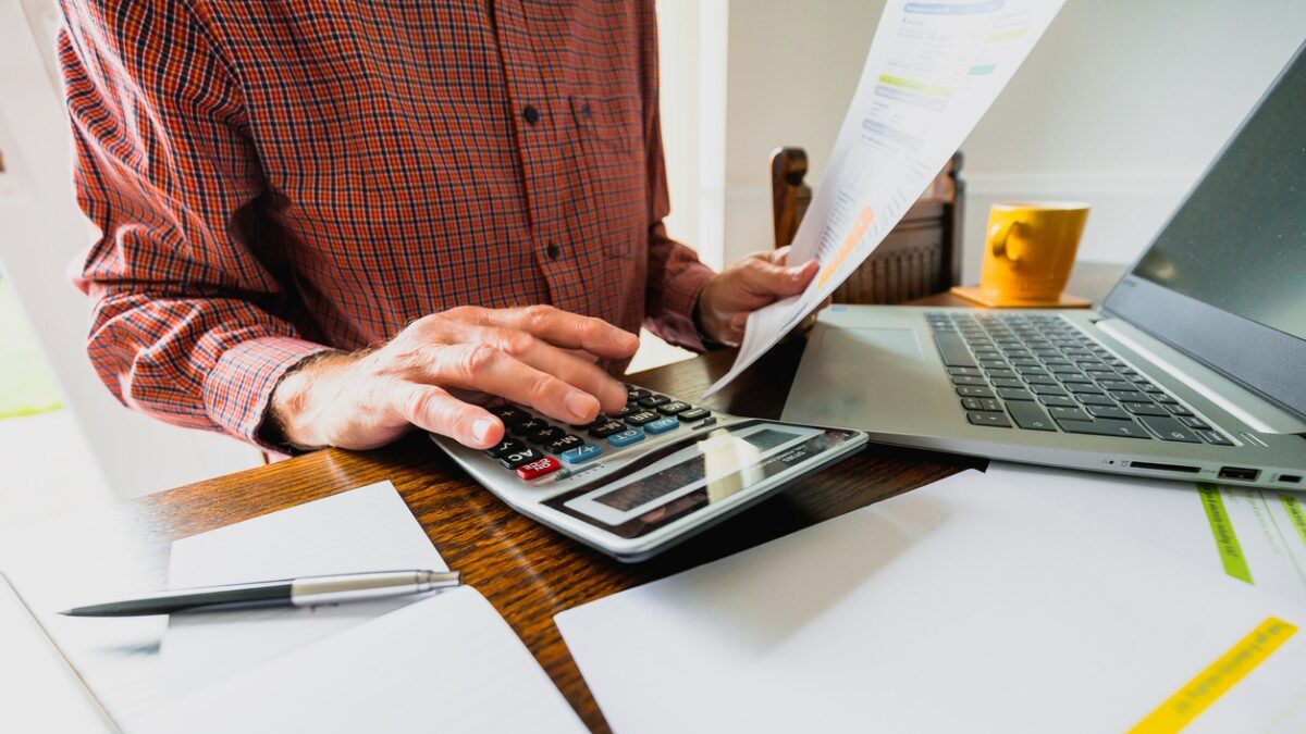 Senior man checking bills