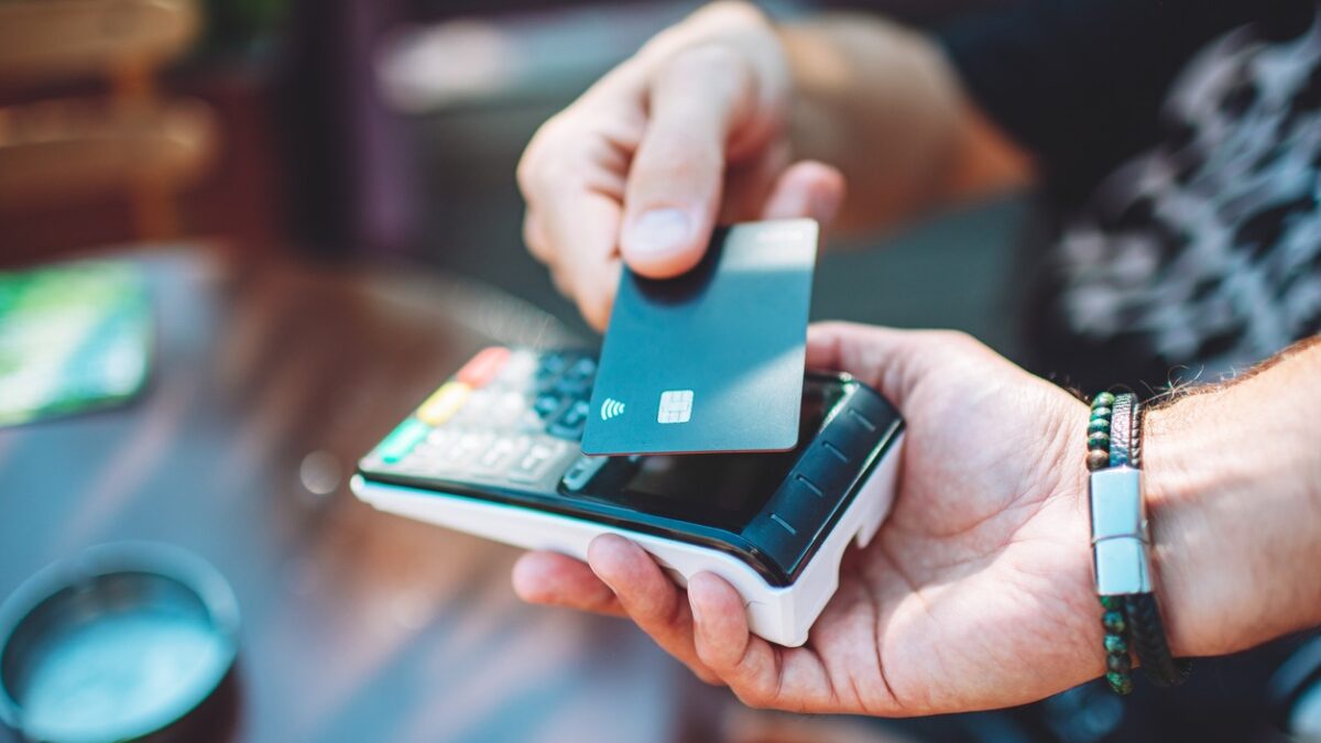 Adult man paying with credit card