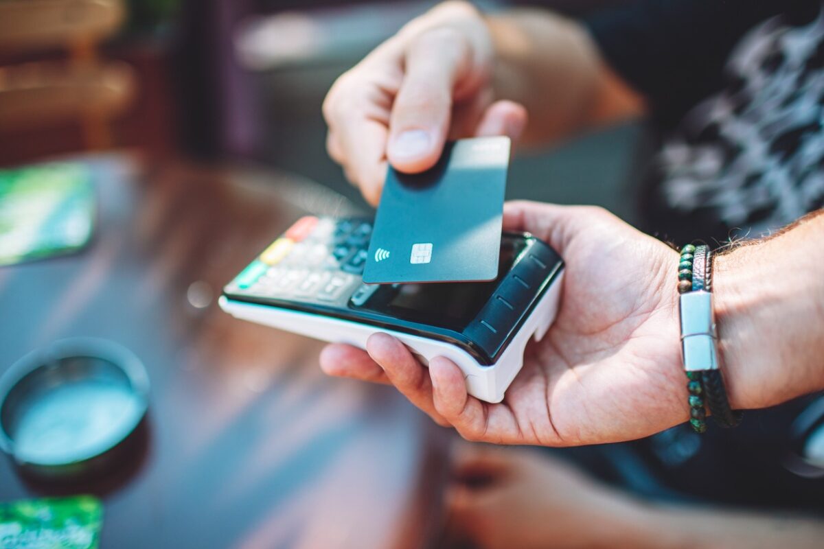 Adult man paying with credit card