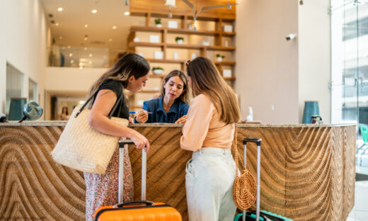 Receptionist talking with customers at a hotel lobby