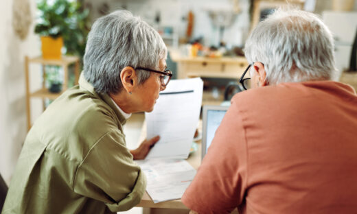 Senior couple going over bills at home