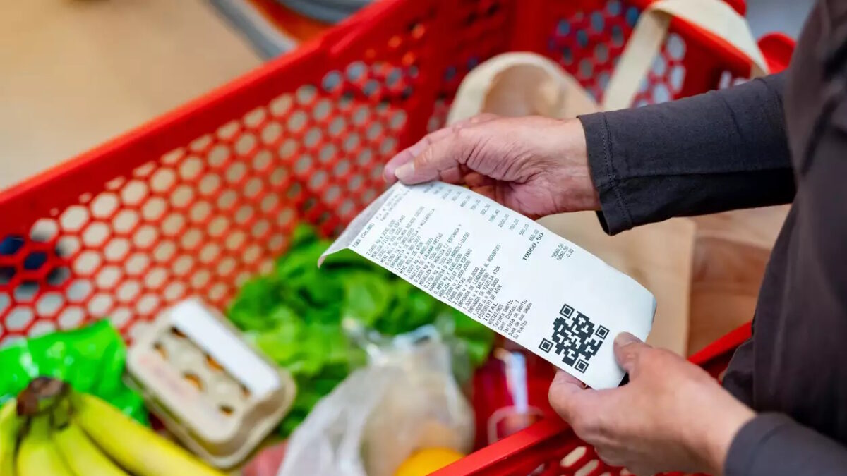 Close up of unrecognizable customer checking her receipt