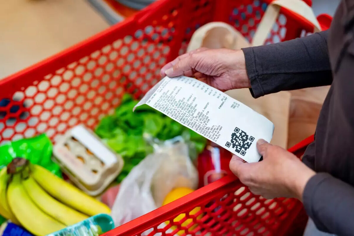 Close up of unrecognizable customer checking her receipt