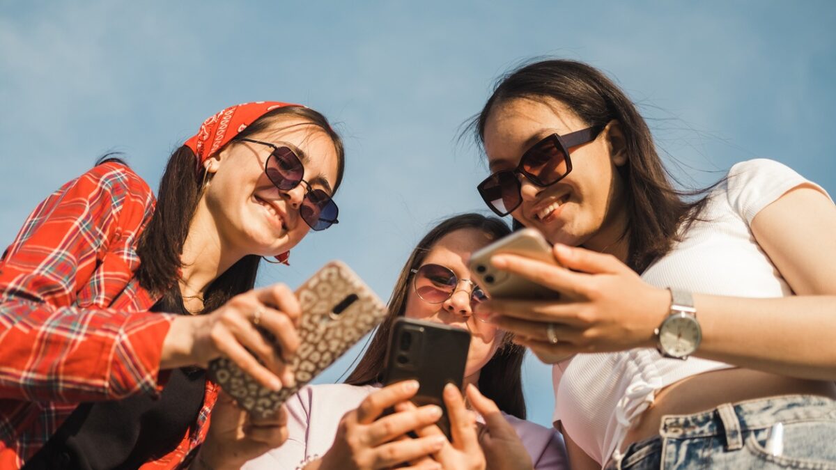 Group of young people using mobile phone