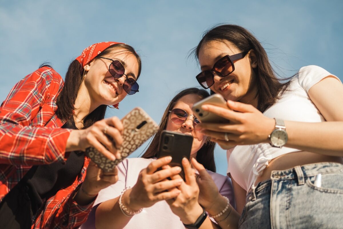 Group of young people using mobile phone