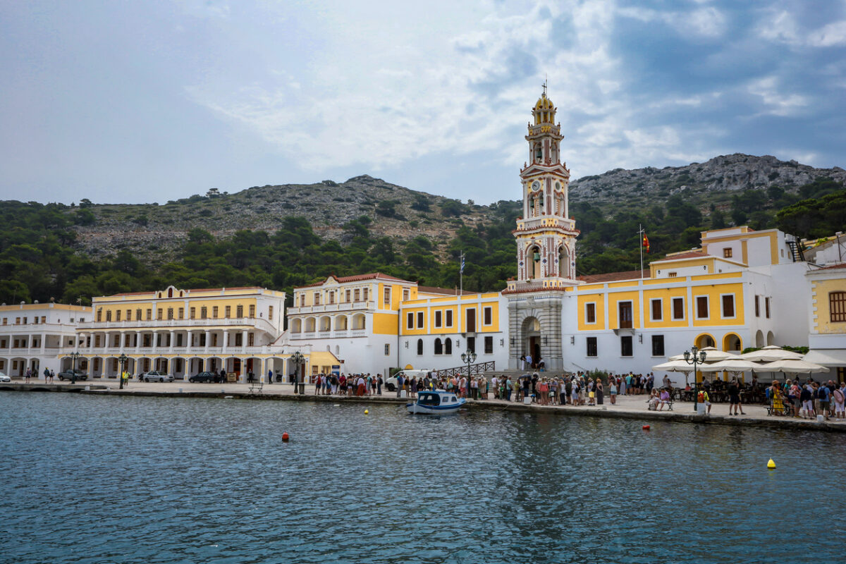 Symi, Greece - May 30, 2023:  Monastery of Archangel Michael on the sea front of Panormitis village.