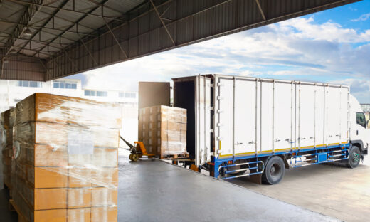 Container Trucks Parked Loading Package Boxes Pallets at Warehouse Dock