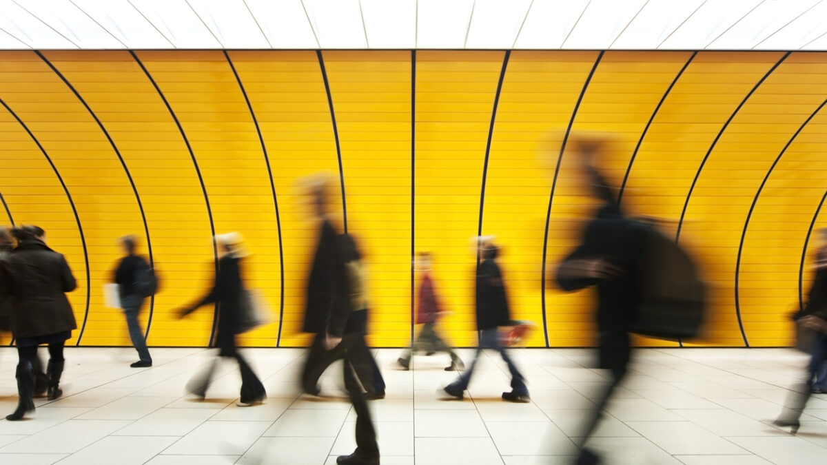 People walking in yellow tunnel