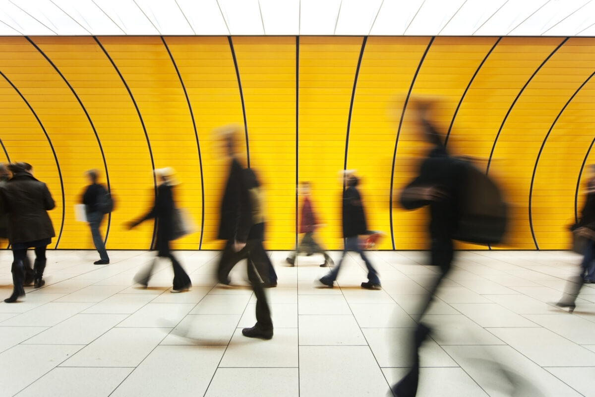 People walking in yellow tunnel