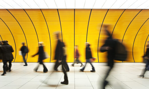 People walking in yellow tunnel