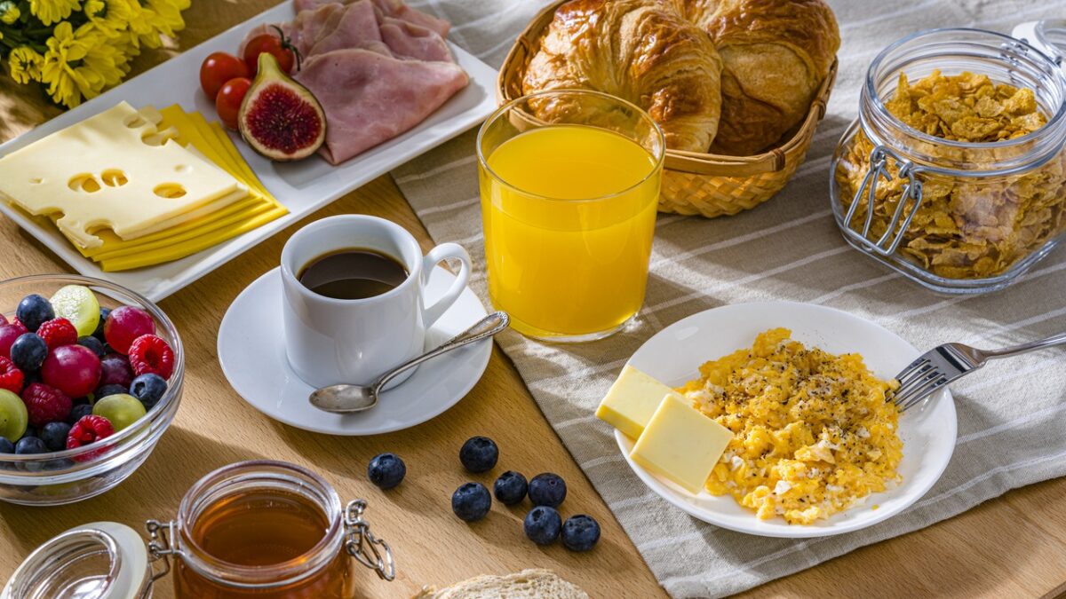 Eggs, cheese, ham, coffee, croissants and fruit juice