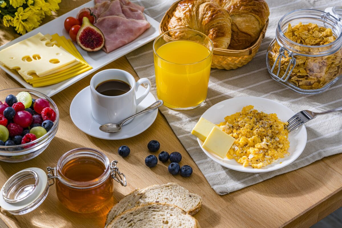 Eggs, cheese, ham, coffee, croissants and fruit juice