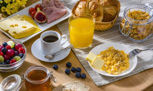 Eggs, cheese, ham, coffee, croissants and fruit juice