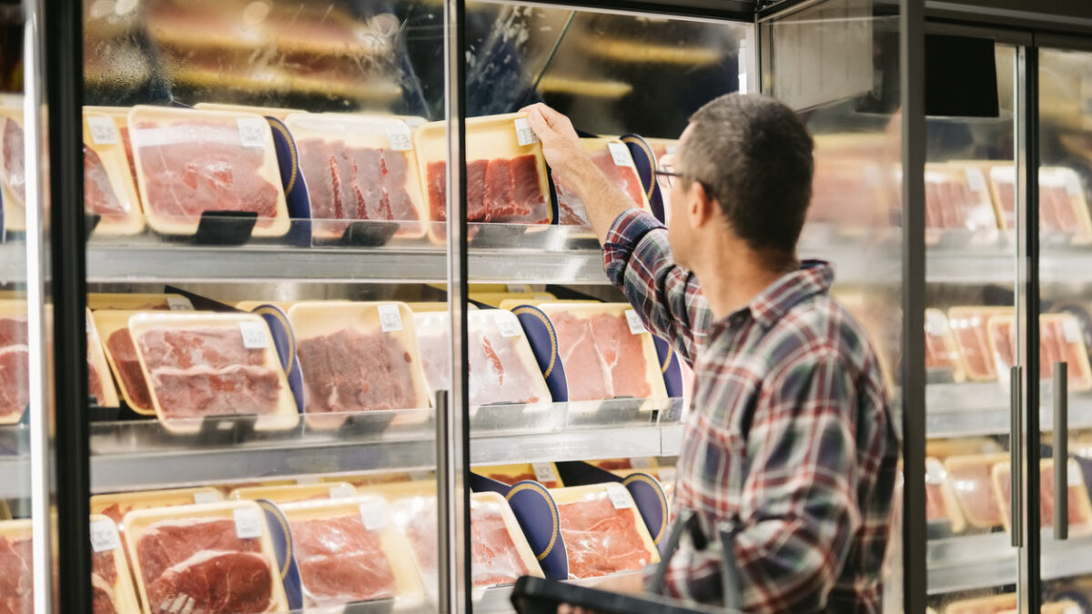 Man buying meat at grocery store