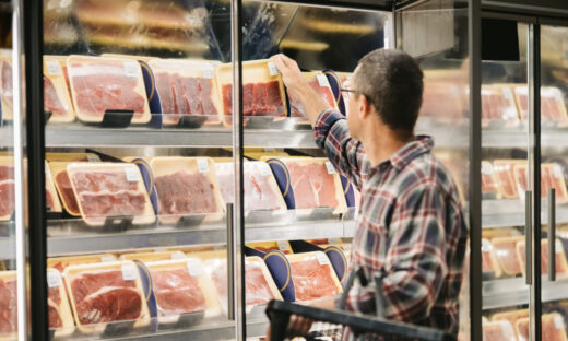 Man buying meat at grocery store