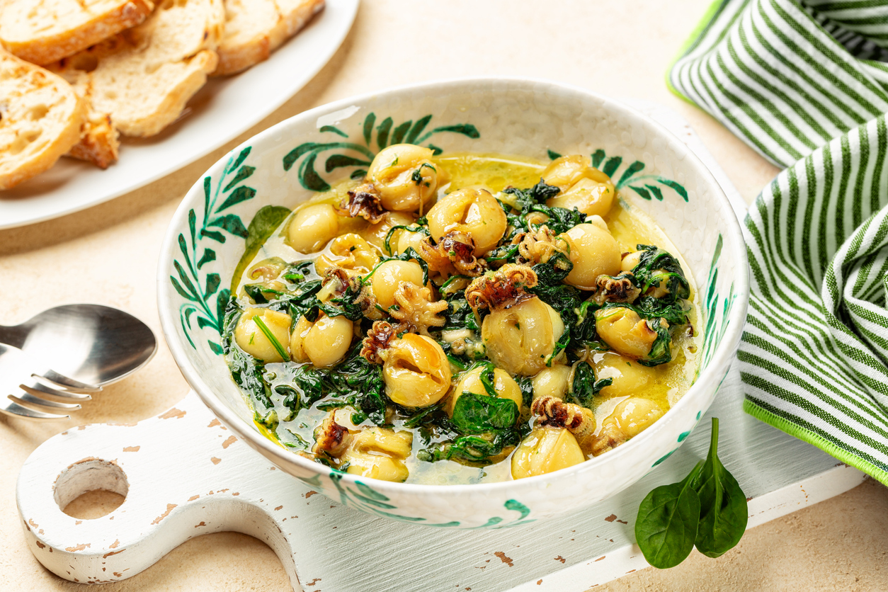 Homemade dinner with Cuttlefish and spinach, Greek classic meal. Toasted bread