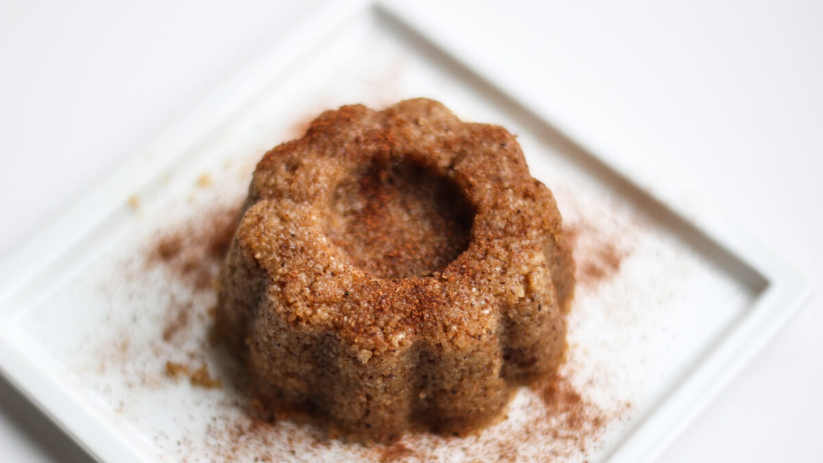 Sweet food, semolina halva on a white plate with white background.