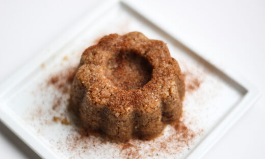 Sweet food, semolina halva on a white plate with white background.