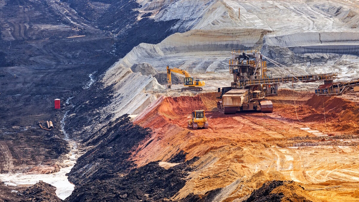 open coal mining pit with heavy machinery