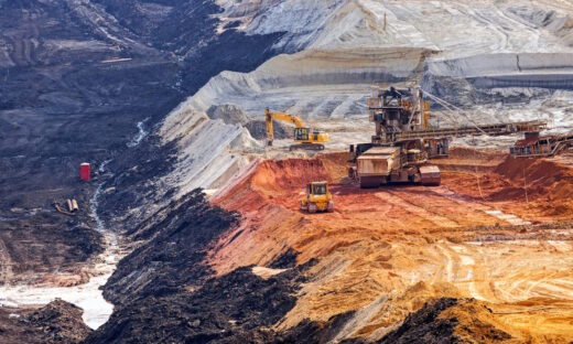 open coal mining pit with heavy machinery