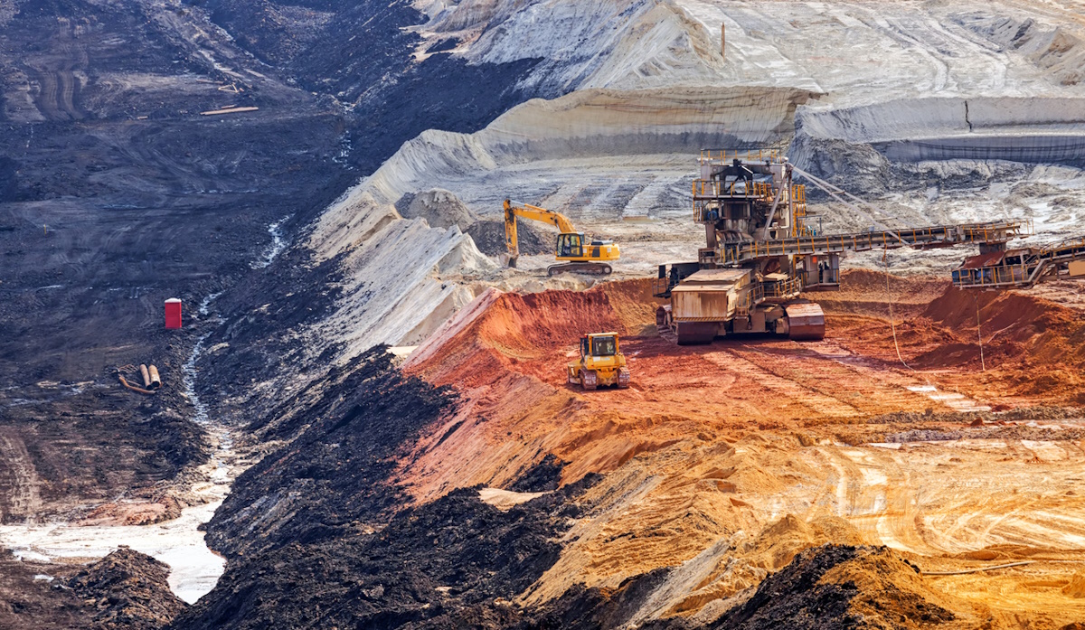 open coal mining pit with heavy machinery