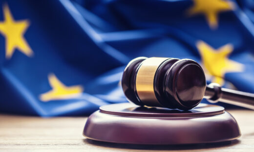 Judges wooden gavel with EU flag in the background