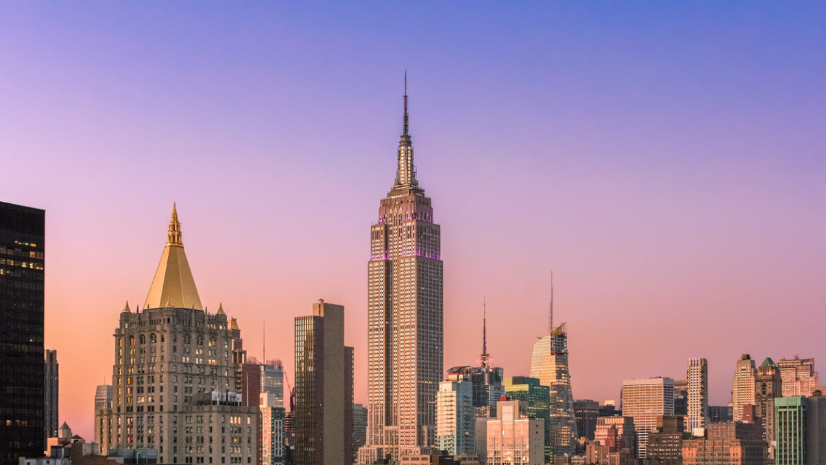 New York City Skyline at Sunset with Empire State Building, Midtown Manhattan Skyscrapers and Clear Sky. Magenta filter