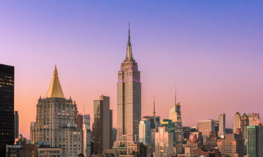 New York City Skyline at Sunset with Empire State Building, Midtown Manhattan Skyscrapers and Clear Sky. Magenta filter