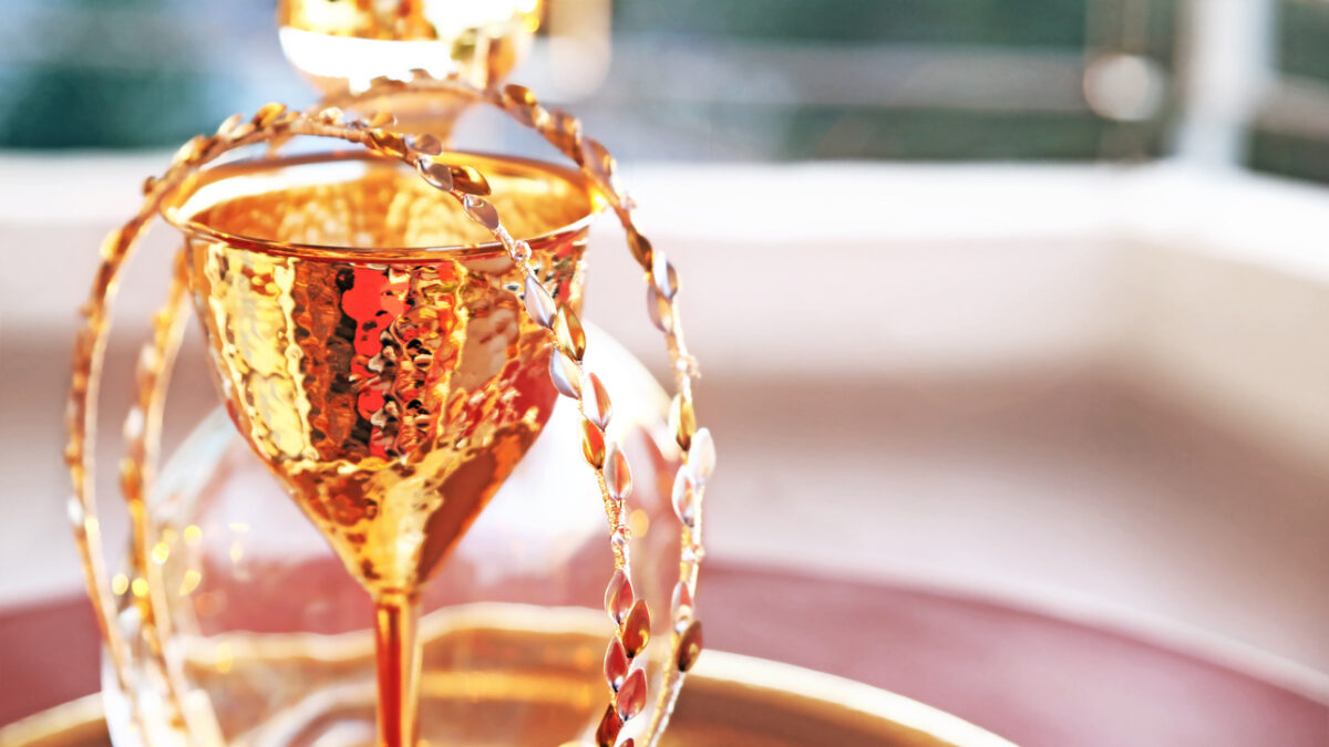 still life photography of traditional wedding crowns, decanter and chalice - greek wedding objects