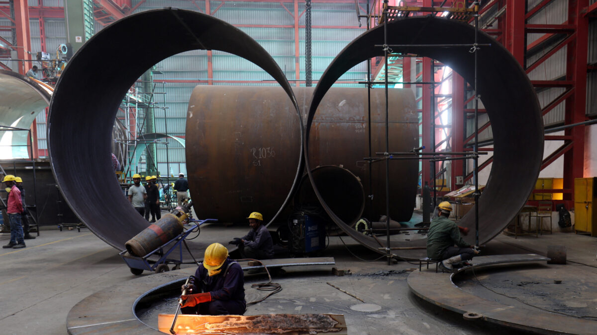 A worker cuts a metal plate inside an industrial tank manufacturing factory on the outskirts of Ahmedabad, India, January 31, 2025. REUTERS