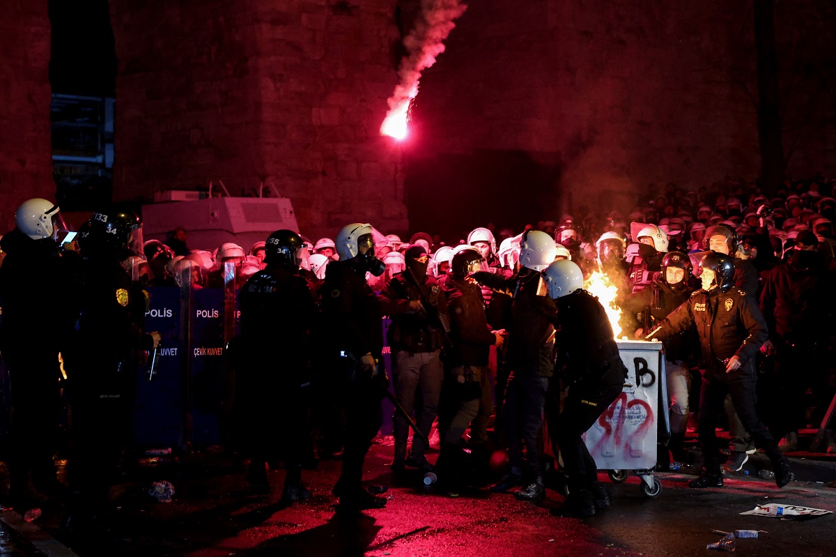 Police officers intervene as flames rise from a fire in a dustbin during a protest by students against the detention of Istanbul Mayor Ekrem Imamoglu, in Istanbul, Turkey, March 21, 2025. REUTERS