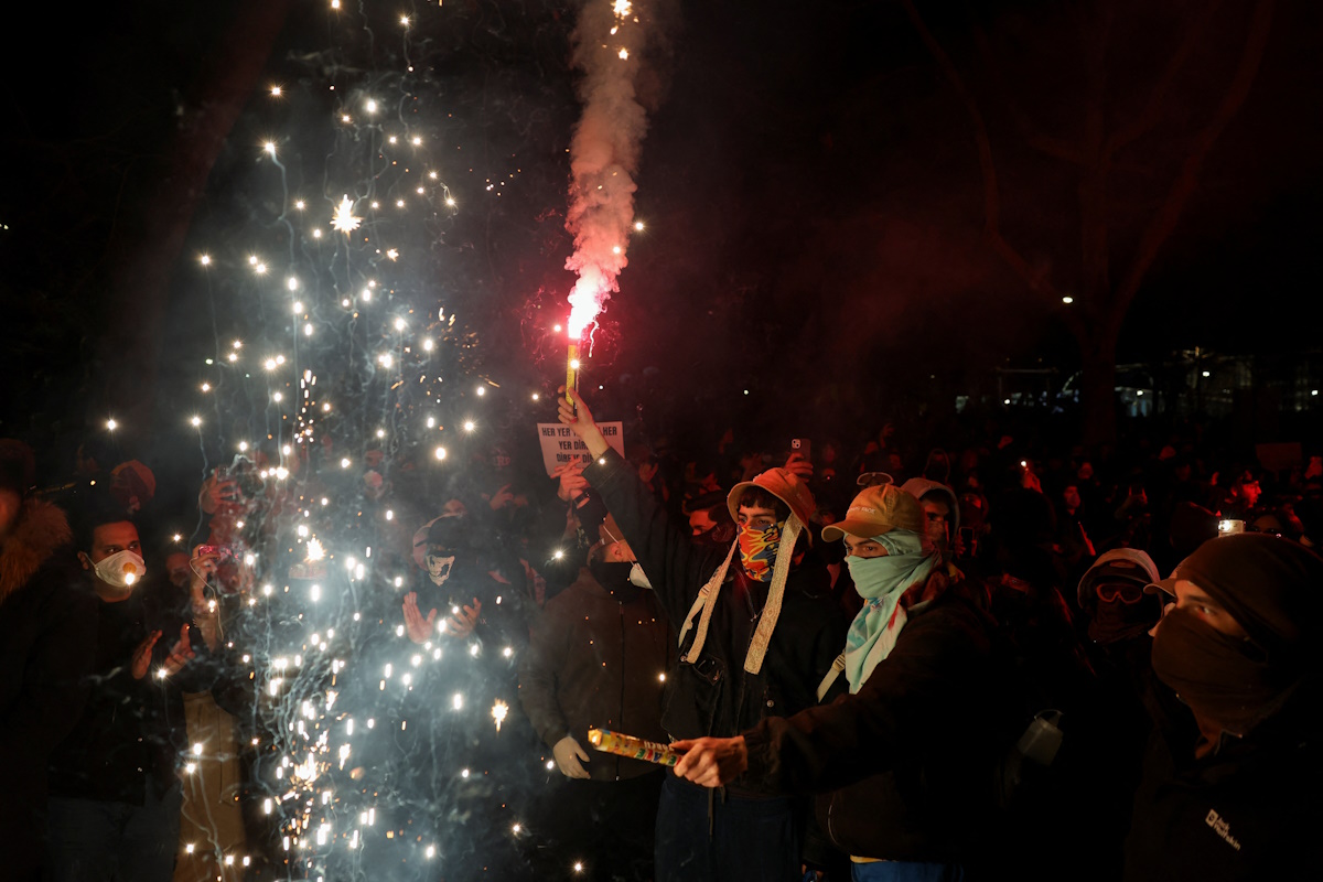 A demonstrator holds a flare as students from several universities take part in a protest against the detention of Istanbul Mayor Ekrem Imamoglu, in Istanbul, Turkey, March 21, 2025. REUTERS