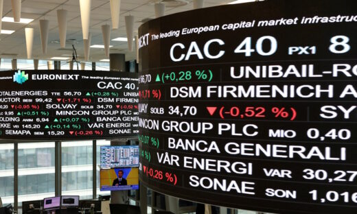 Trading data is displayed on digital boards at the Euronext stock exchange in the La Defense business district in Paris